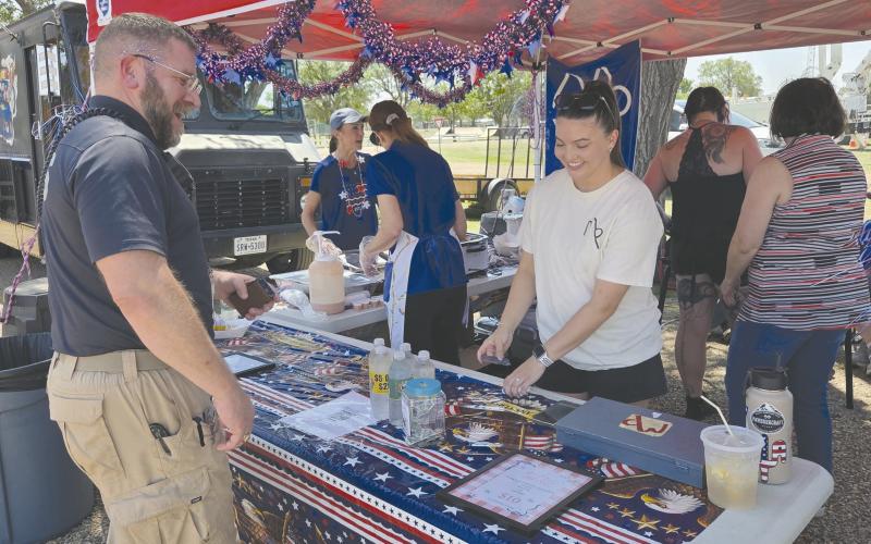 LUNCHTIME ON THE FOURTH Locals who turned out for the Fourth of July celebration at Leatherman Park got to enjoy lots of activities, contests, fireworks, and much more. And whenever they needed some fuel to keep themselves going, there were plenty of food trucks on hand to serve up lunch, snacks, or a cold drink. Pictured picking up lunch from a booth set up by the Museum of the Plains is Jeff Mincy, at left, and Yancy Judice.