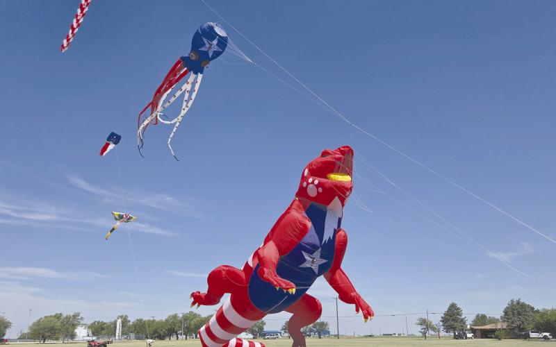 GIANT DINOSAURS IN THE PARK— Perryton saw a gigantic celebration on July 4 at Leatherman Park. In addition to a car show, farmers market, multiple contests and concerts, food trucks, and fireworks, Kites in the Field over Texas brought the spectacle to the celebration with gigantic inflatable kites, including this tremendous floating dinosaur.
