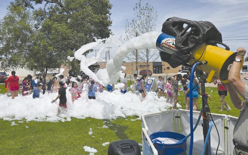 FUN IN THE FOAM For the last session of Perry Memorial Library’s annual Summer Reading program, kids got to celebrate with a special foam party on last Thursday afternoon. Kids broke out their swimsuits, sunglasses, and flip-flops to dance and play in torrents of biodegradable, hypo-allergenic, soap-like foam shot out of a large foam cannon.