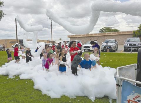 For the last session of Perry Memorial Library’s annual Summer Reading program, kids got to celebrate with a special foam party on last Tuesday afternoon. Kids broke out their swimsuits, sunglasses, and flipflops to dance and play in torrents of biodegradable, hypo-allergenic, soap-like foam shot out of a giant foam cannon.