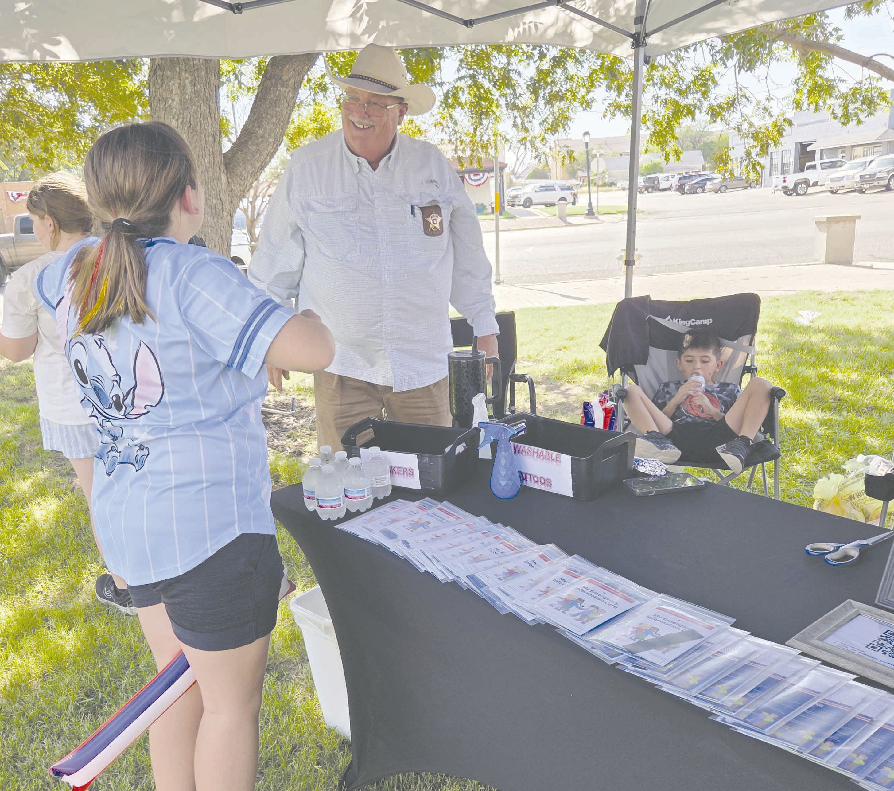 The annual block party, sponsored by the Perryton Ochiltree Chamber of Commerce, brought local residents out last Thursday evening to enjoy snacks and activities at the county courthouse and along downtown Main Street. Ochiltree County Sheriff Terry Bouchard and his staff from the Sheriff’s Office sponsored a booth at the courthouse lawn to distribute kids’ DNA kits, along with fun activity booklets.