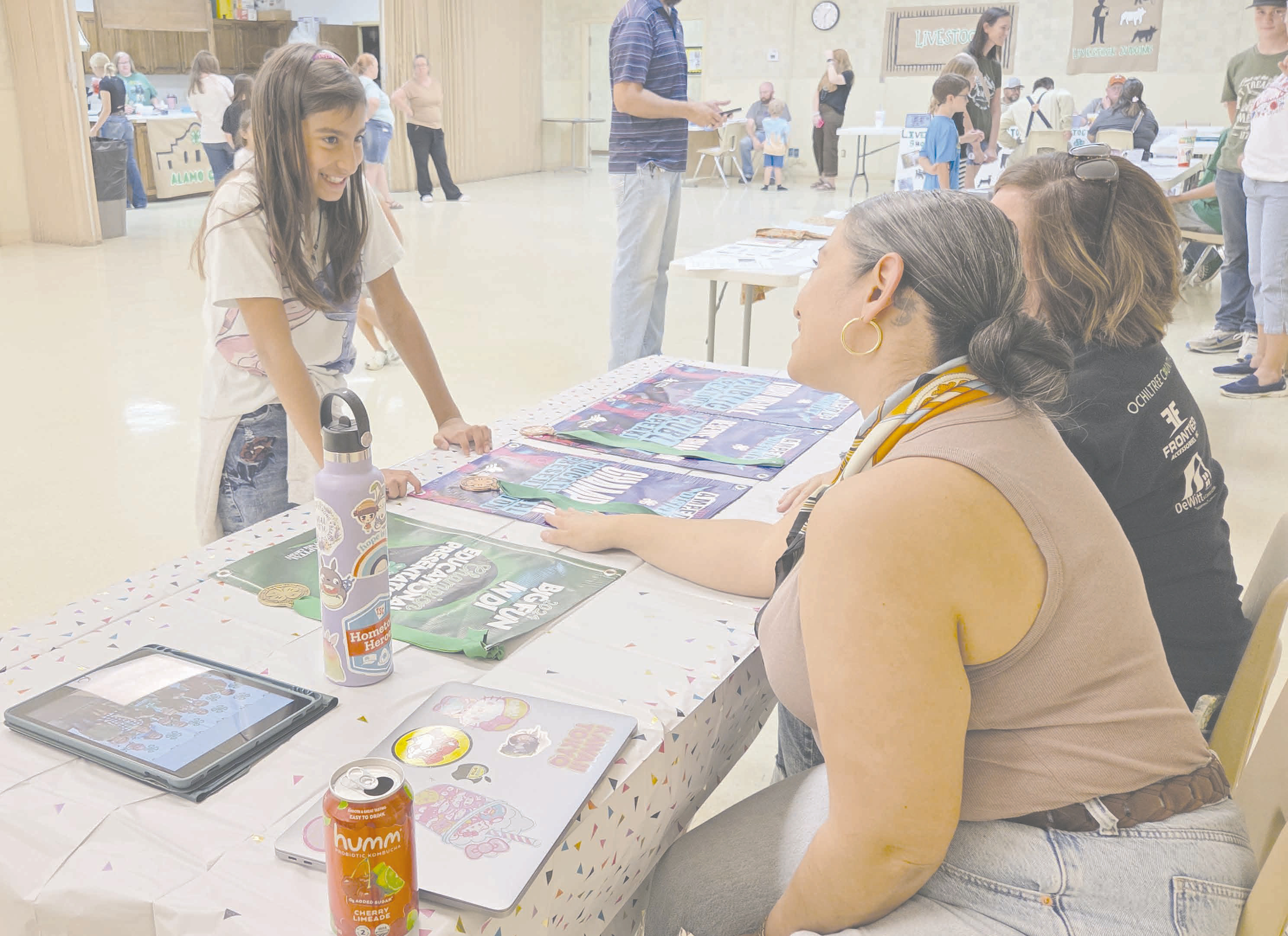 Ochiltree County 4-H held a special Recruitment Night event on Tuesday evening at the Ochiltree County Expo Center. 4-H parents, managers, and leaders met new club members and spoke to them about projects within the organization, including livestock judging, shooting sports and archery, public speaking, food and nutrition, and more. Pictured is Eden Salazar, age 10, chatting with project leaders Wendi Salazar and Dana Oquin about 4-H’s Public Speaking program.