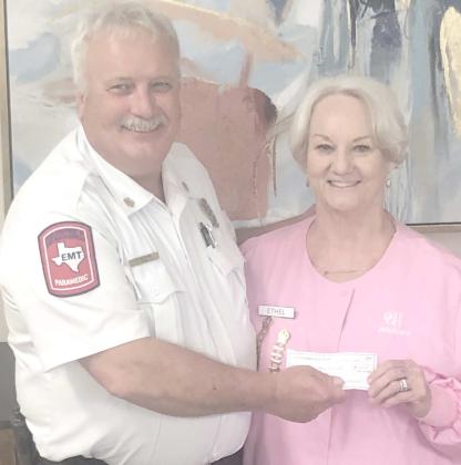 The Ochiltree General Hospital Auxilliary presented a donation of $1,000 to the volunteer fire department during their meeting at the Senior Citizen Center on April 1. Pictured are Perryton Fire Chief Paul Dutcher and Hospital Auxiliary president Ethel Rudd.