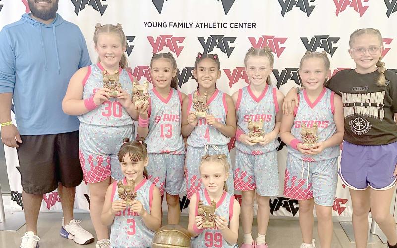 TAKE SECOND AT NATIONALS— The Top of Texas Stars or first and second graders took second place in the national Mid America Youth Basketball tournament in Norman, OK. They played teams from Atlanta, GA; Shreveport, LA; and three Kansas teams. Pictured with their trophy are in front, Isa Tarango and Cye Carson; and in back, Coach Chris Najera, Abby Waterbury, Paislee Najera, Addie Tarango, Sloan Kile, Goldie Sloan and Assistant Coach Aubri Carson.