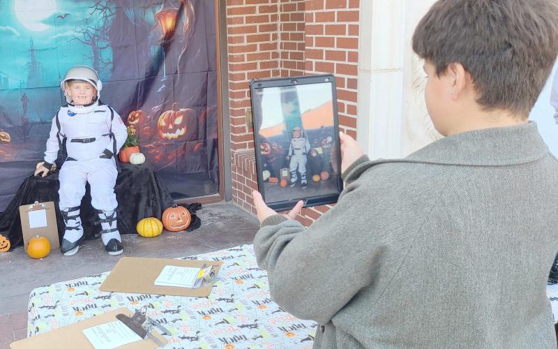 LIFTOFF FOR HALLOWEEN— Perryton residents turned out downtown on Oct. 15 for sales, entertainment, and fun snacks during the Perryton Ochiltree Chamber of Commerce’s annual Moonlight Madness event. Lots of kids showed up to enter the Chamber’s annual costume contest. Pictured are, from left, young astronaut Mason McDaniels, age 6, and Drake Vasquez, 12, taking photos of costume entrants for the Chamber.