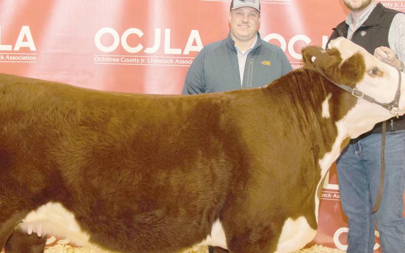 GRAND CHAMPION HEIFER— At the Ochiltree County Junior Livestock Show and Sale on Jan. 19-20, Evan Born took home the award for Grand Champion Heifer. His animal was purchased by FirstBank Southwest. Pictured are, from left, Darren Chisum and Evan Born. ( Photo credit: Tessa Powell)