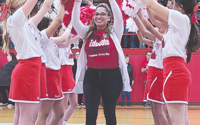 A TRIBUTE TO TEACHERS AND STUDENTS Perryton Junior High held a pep rally Monday to celebrate the school’s improved academic status, as it earned an official “Acceptable” rating from the Texas Education Agency. Teachers and students at PJH were congratulated by PISD administration staff, school board members, and representatives from TEA and the Region 16 Service Center. Pictured running through the PJH cheerleaders’ pom-pom tunnel is English teacher Maribel Murillo.