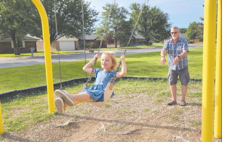 After several days of brutally hot weather, Ochiltree County finally got a small cooldown on Wednesday morning. Still, summer’s heat meant that many resident preferred to get their outdoor work and play done in the morning, when it was coolest. Pictured enjoying the swings at Whippo Park are Kinley Stevenson, age 6, and Matt Sheppard.