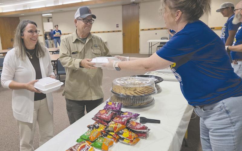 Frank Phillips College, Allen Campus hosted a pulled pork dinner fundraiser Tuesday evening for the Perryton Pathways scholarship program. Hungry diners had dine in, take out, and delivery options available, as well as a silent auction. Pictured are Phil and Lori Dollar picking up their meal from volunteer Misty Stockton. Pathways is open to PHS freshmen and eligible sophomores, juniors, and seniors.