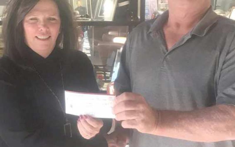 Perryton Elks Lodge 2368 donated $4,000 to the VA Hospital in Amarillo to help with supplies for residents of the facility. The donation was made possible through one of the grant programs available to Elks Lodges across the country. Pictured are VA representative Trisha Reid, left, and Elks Exalted Ruler Dewayne Holdeman.