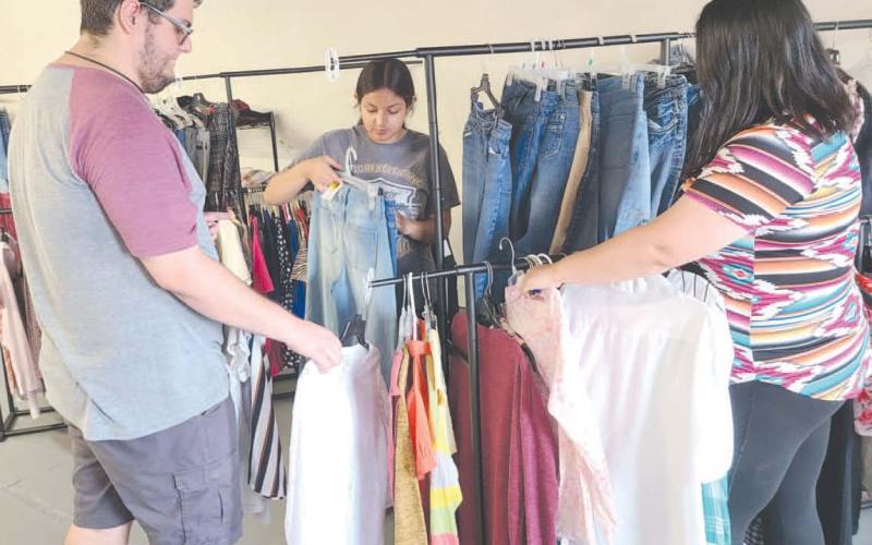 The Panhandle Crisis Center’s Resale Store opened at a new temporary location at 21 SE 12th Street on August 1. The old store sustained heavy damage in the tornado on June 15. The store will be open Monday through Friday from 10 a.m. to 5:30 p.m. No donations are being accepted at this time. Pictured getting the store restocked prior to its opening are, from left, Rhett Schaef, Jade Gonzales, and Marisol Hernandez.