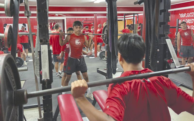The Perryton High School Rangers have been hard at work for the past few weeks preparing for the upcoming season. While that includes memorizing plays and practicing passes and blocks, it also includes weight training to boost their strength and stamina. Pictured are Ivan Chavez in the back, with Khadyn Juarez spotting just behind him, and Alex Venegas in the foreground. The Rangers will play their season opener on Thursday, Aug. 28, at 7 p.m. in Canyon.