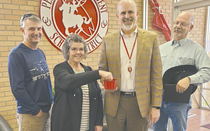 The candidates for the Perryton Independent School District board election met on Monday afternoon at the PISD Administration Building to draw for ballot position for the election. Jeff Schollenbarger will be in first position on the ballot, followed by Bryce Hale, Wes Beal, Nuno Rodriguez, Chris Lingo, and Kevin Pshigoda. Pictured are, from left, Schollenbarger, payroll clerk Lesa Kemp, who drew the names for the ballot, PISD Superintendent Greg Brown, and Beal.