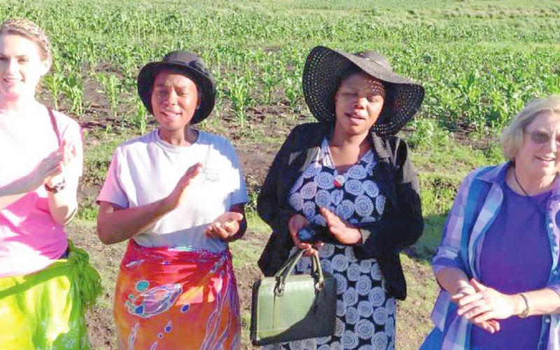Kamber Burleson Henson, two Lesotho residents and Carolyn Thurman