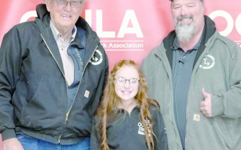 GRAND CHAMPION HEIFER— At the Ochiltree County Junior Livestock Show and Sale on Jan. 16-17, Blakelee Gillispie took home the award for Grand Champion Heifer. Her animal was purchased by Broken Arrow Crop Insurance. Pictured are, from left, Larry Schickedanz, Blakelee Gillispie, and Jason Schickedanz. ( Photo credit: Hailey Clark of Hailey Renee Photography)