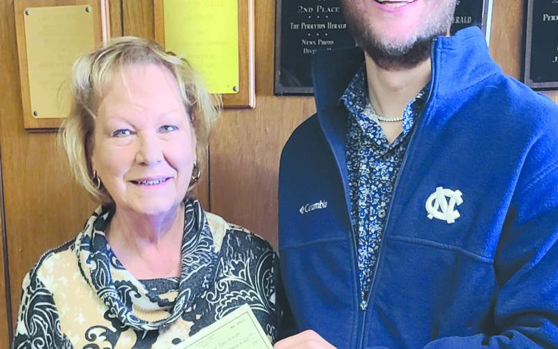 Daniel Hillman emerged the winner of the Herald’s annual football contest, accumulating 60 points for the win. As the winner he received four tickets to a semifinal college playoff game at AT&amp;amp;T Stadium in Arlington, valued at around $1,500. He also received $200 in expense money. Pictured with him is Herald publisher Mary Dudley.