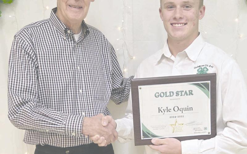 Ochiltree County 4-H held their annual awards ceremony Tuesday evening at the Ochiltree County Expo Center. The winner of the Gold Star Award, the highest county award that can be given to a 4-H member was Kyle Oquin, who received a plaque from the county, a pin, and a certificate from the state. Pictured are, from left, County Judge Charles Kelly, who presented the award, and Oquin.