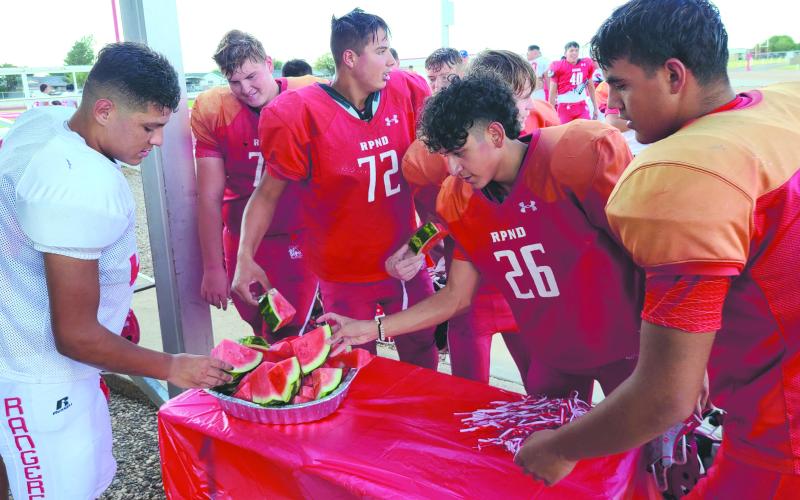 The weather is still brutally hot, and two-a-day practices for Perryton High School’s football teams are even hotter. So Texas Farm Bureau brought out a few platters of cold watermelon to help cool the teams off after a full day of practices. Players in varsity, junior varsity, and freshmen squads will travel to Happy State Bank Stadium in Canyon on Friday, Aug. 19, to play scrimmages against Abernathy.