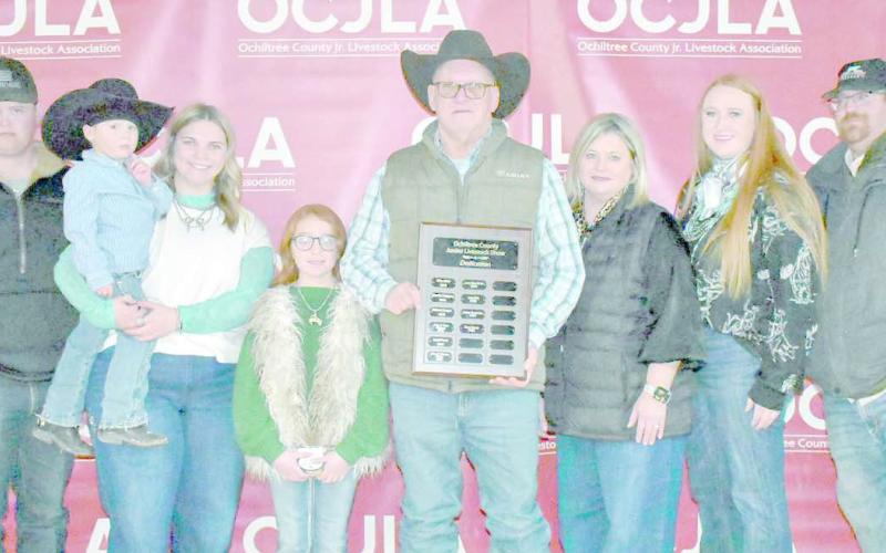 This year’s Ochiltree County Junior Livestock Show and Sale was dedicated to Gary Murry. Pictured are, from left, Logan Martin, Tucker Gillispie, Raylee Murry, Blakelee Gillispie, Gary Murry, Rhonda Murry, Ali Gillispie, and Matthew Gillispie. (Photo credit: Morgan Dudley)
