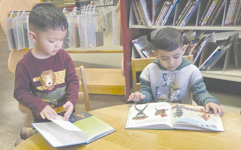 Kids in Perryton gather every week at Perry Memorial Library to enjoy Story Time, which takes place every Wednesday from 10-11 a.m. The program, for kids from 2-4 years old, is free, but library staff request you call ahead and register so they know how many crafts they’ll need to make. Pictured getting a little extra reading done while waiting for the program to start are, from left, Jasiel Ortiz, age 3, and Isael Olmos, 4.