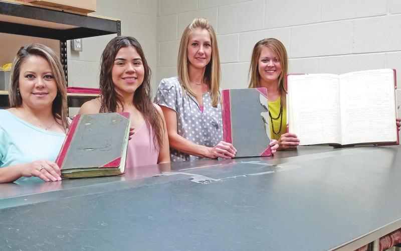 PRESERVING THE COUNTY’S OLDEST RECORDS Three vital record books from the early years of Ochiltree County have been chosen for preservation efforts. Two of the books date from the early decades of the 20th century, while the other stretches all the way back to 1889. Pictured with the three books to be preserved are members of the Ochiltree County Clerk’s office: from left, deputy county clerks Sandra Limas, Dyani Lozano, and Jeri Ann McGarraugh, and county clerk Cassi Laxton.
