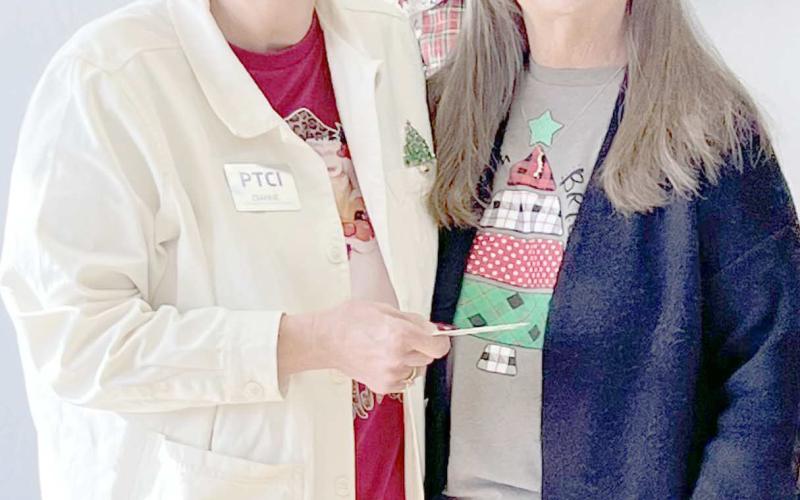 PTCI CHRISTMAS WINNERS— PTCI gave away two $50 gift certificates over the holidays. The first winner was Angela Petersen, with son Mikel and Dianne Felix from PTCI, left photo, and the second winner was Cyndi Bollinger with Felix.