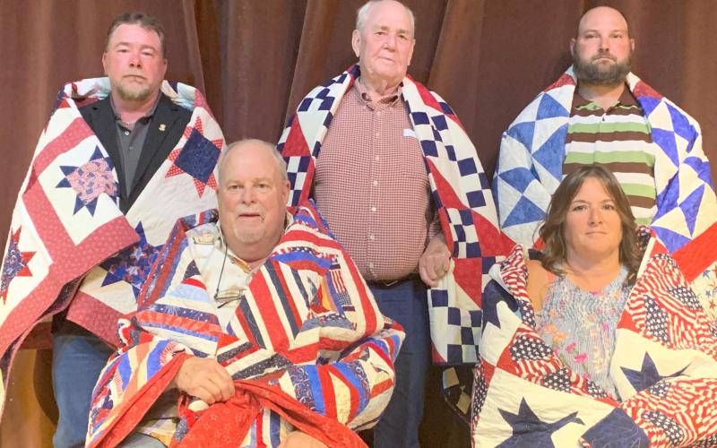QUILTS OF VALOR RECIPIENTS—These 10 veterans were part of a group of 19 recipients who were presented with Quilts of Valor by the Friendship Quilt Guild Sept. 9. In the top photo are, first row, from left, Jerry Buxton and Bill Stone; and second row, REnee Huston, Jack Terhune and Rooster Herring. In the bottom photo are, first row, from left, Tom Rickard and Nikki Green; and second row, Mike Caddell, Sam Howard and Chase Allison.