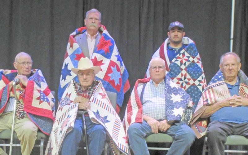 QUILT OF VALOR RECIPIENTS— Among the 16 veterans honored with Quilts of Valor by the Friendship Quilt Guild were seven men honored in the second group. They were, first row, from left, Billy Britt Jarvis, Dick Wilberforce, Wallace Forrest and Ken Schafer; and second row, John Worthington and Mike Itera. Not pictured is Robert Cruz. The special presentation was made Oct. 20.