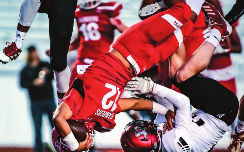 RANGERS ROLL OVER THE COMPETITION Ranger Abraham Hernandez (#12, junior) barrels over a Lobo as the Rangers took an early lead and never looked back on Friday evening versus the Levelland Lobos. The win was their first district game of the season, and they dominated the Lobos 34-7 at Ranger Field. The Rangers’ next game is Thursday, where they travel to Lubbock. (Photo by David Erickson)