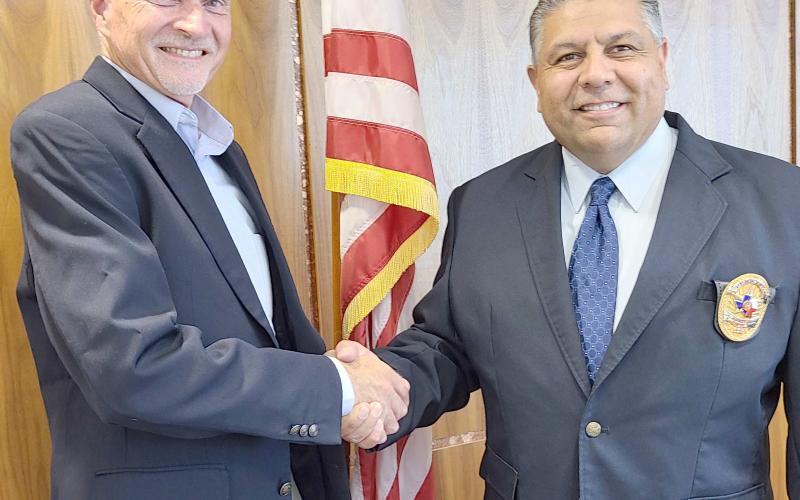 NEW POLICE CHIEF SWORN IN— The Perryton Police Department’s new chief, Nick Yara, was officially sworn in on Monday afternoon by City of Perryton Secretary Kim Fowler. Yara succeeds former chief Mike Smith, who officially retired last Friday. Pictured are Yara, at right, with Perryton City Manager David Landis.