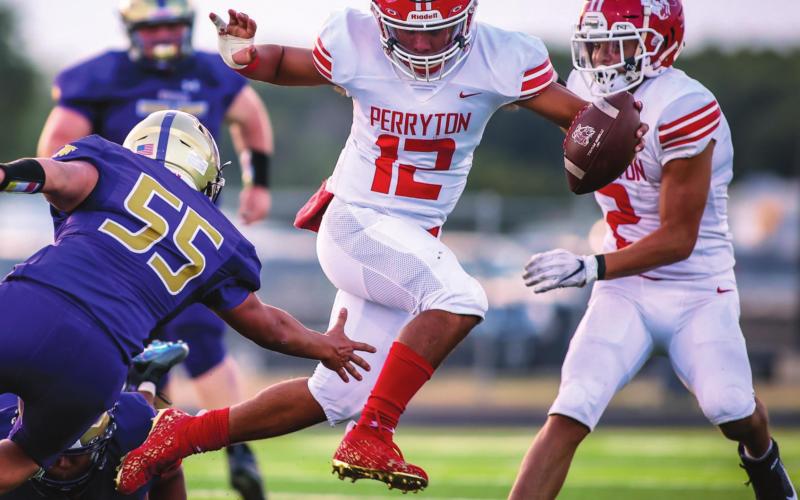 OPENING WITH A WIN Abraham Hernandez (#12, senior) dodged a Dalhart defender as the Perryton Rangers downed the Dalhart Golden Wolves in their season opener Friday in Dalhart. The Rangers notched a win, 27 to 6. They hit the road again next Friday to face the Childress Bobcats. Kickoff is at 7:00 p.m. See story for more information. (Photo by David Erickson)
