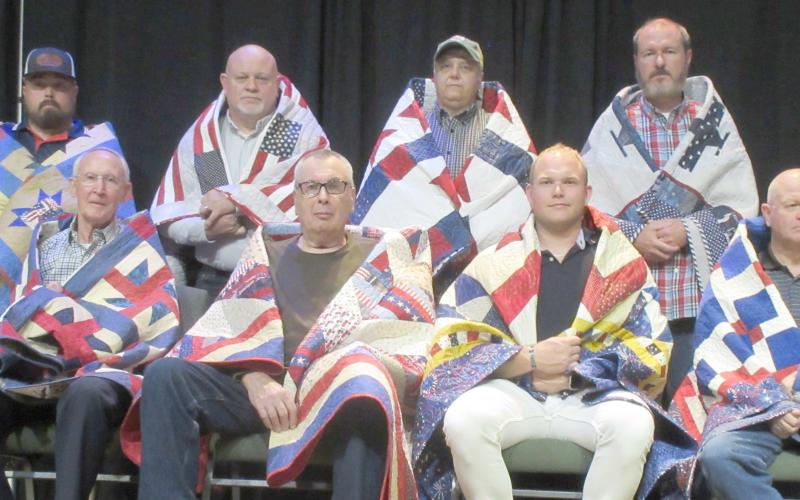 QUILTS OF VALOR PRESENTATIONS— The Friendship Quilt Guild presented 16 Quilts of Honor on Oct. 20. The quilts were given in two groups. The first group included, first row, from left, Charles Kelly, Dave Patterson, Tyler Harper and Mike Richardson; and second row, J.W. Brown, Matthew Harper, Stacy Brown and Ron Bishop. Not pictured is Stephen Montgomery “Monty” Joiner.