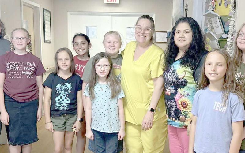 4-H MEMBERS SEW PILLOWCASES FOR CAPSTONE RESIDENTS— Ochiltree County 4-H members in the fashion/beginner sewing class learned basic sewing skills by hand and on the sewing machine. They constructed 19 pillowcases for residents at Capstone Healthcare of Perryton as a final project. Pictured are, from left, senior leader Rylan Oquin, Hannah Young, Izzy Heck, Madison Knox, Isabella Gonzalez, Madison Knox, Rebekah Young, Capstone LVN Melissa Windham, CNA Gloria Gonzales, Gabby Heck and Kylee Knox.