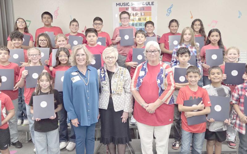 DAR CELEBRATES CONSTITUTION DAY AT WILLIAMS— Members of the local Wolf Creek chapter of the National Society Daughters of the American Revolution visited Williams Intermediate Elementary School last Thursday to commemorate Constitution Week by delivering copies of the United States Constitution for every fifth grade classroom. Pictured with a small horde of Williams fifth graders are, in front, Melodee Rogers, Barbara Johnson, and Debra Dye.
