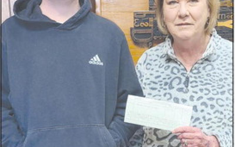 FOOTBALL CONTEST WINNER Paxton Denton was the grand prize winner of the Herald’s annual football contest, with an impressive 70 points. As the winner, he received four tickets to the Goodyear Cotton Bowl at AT&amp;amp;T Stadium in Arlington Jan. 2, and $200 in expense money. Pictured with him is Herald publisher Mary Dudley.
