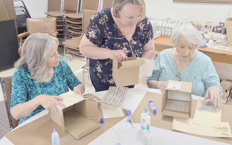 The Ochiltree County Senior Citizens Association hosted a crafting project for members at Senior Center on Monday afternoon, as staff at Paper and Cloth Memories demonstrated how to make memory boxes. Pictured are, from left, Becky Childers, Brenda Austin, and Berwyn Flowers.