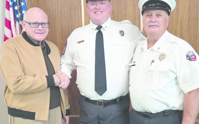 Ed Hanna was sworn in on Dec. 5 as the City of Perryton’s new Fire Department Chief. The brief ceremony came at the end of the retirement reception for outgoing chief Paul Dutcher. Pictured are, from left, Perryton Mayor Kerry Symons, Hanna, and Dutcher.
