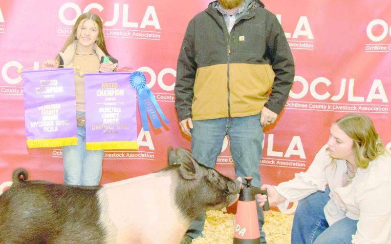 GRAND CHAMPION SWINE— At the Ochiltree County Junior Livestock Show and Sale, Hallie Lopez took home the award for Grand Champion Swine. Her animal was purchased by Wright Water Well Services and Allen Irrigation. Pictured are, from left, Hallie Lopez, Steven Wright, and Raylee Murry. (Photo Credit: Tessa Powell)