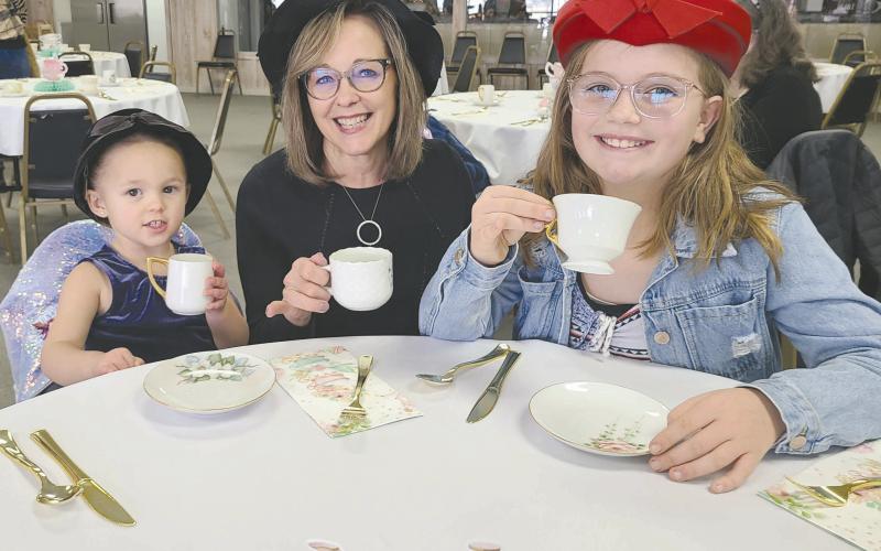 TEA AND SOPHISTICATION Parents, kids, and grandparents of all ages dropped by the Museum of the Plains on Sunday afternoon to enjoy an old-fashioned afternoon tea party. Some 45 residents picked out fancy hats to wear and enjoyed tea, punch, finger sandwiches, cookies, and plenty of good company, as well as checking out the museum’s new display of vintage dolls. Pictured are, from left, Alexia Campbell, age 2, grandma Rhonda Appelhans, and Brystol Appelhans, 10.