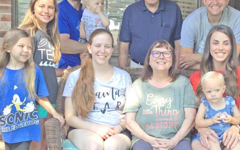 Cindy Shackelford and family: at left, son Scott, his wife Kami and daughters Emma, Zoey and Saylor; and at right, son Ben and his wife Annie with son Caleb; and behind her, husband Danny