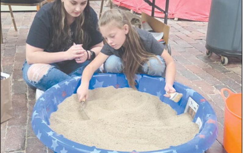 Family Archaeology Day, held last Saturday at the Museum of the Plains, gave kids and adults lots of ways to learn about the science of archaeology, including carefully sifting through an artificial archaeology dig to find artifacts, fossils, unusual stones, and more. Attendees at the event also got to enjoy art, crafts, games, and much more. Pictured looking for artifacts in the artificial archaeology dig are Lauren Goza and Juliza Thomas, age 7.