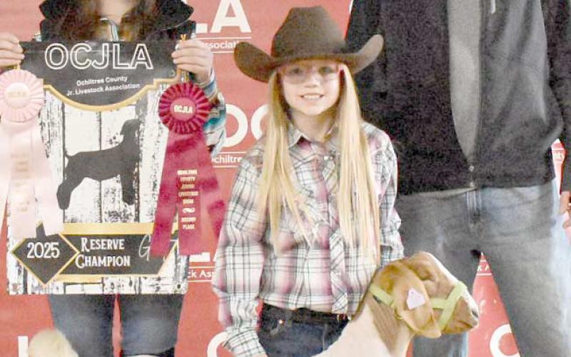 At the Ochiltree County Junior Livestock Show and Sale on Jan. 17-18, Madeleine Jumper took home the award for Reserve Grand Champion Goat. Her animal was purchased by Perryton Realty. Pictured are, from left, Amelia Jumper, Madeleine Jumper, and Bryce Hale. ( Photo credit: Morgan Dudley)