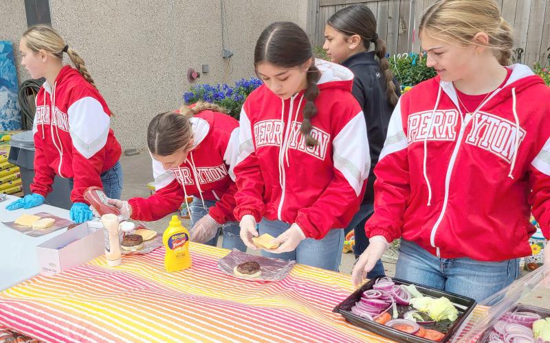 PJH CHEERLEADERS HOLD BURGER FUNDRAISER— Perryton Junior High School’s Cheerleaders held a hamburger fundraiser last week at United Supermarkets. Participants could order a fresh-cooked hamburger with all the fixins grilled up by the cheerleaders and their sponsors. Proceeds from the fundraiser will help fund new uniforms and equipment, trips, and much more.