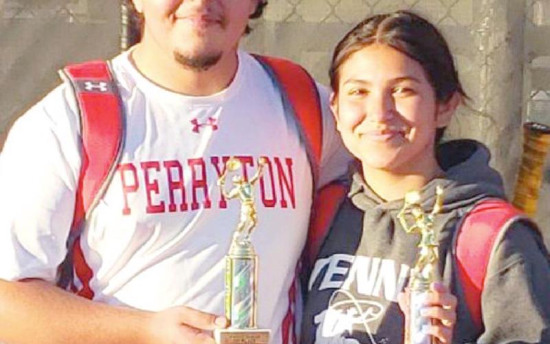WINNING DUO—PHS mixed doubles team Manuel Granillo and Yadira Ontiveros flash some of the hardware they have won this season in the event.
