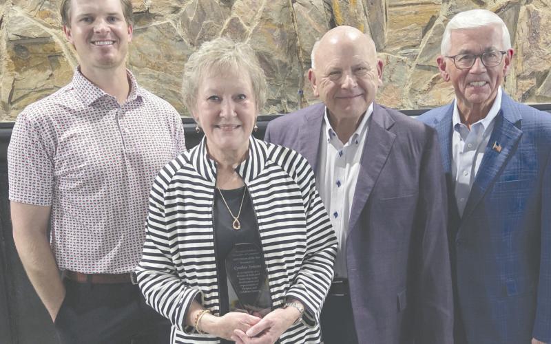 Cynthia Symons received congratulations from many well-wishers after she was named the Citizen of the Year on Feb. 19 during the Perryton-Ochiltree Chamber of Commerce’s annual banquet. Pictured are, from left, banquet emcee Dr. Jay Blasingame, Cynthia Symons, Kerry Symons, and presenter Randy Brillhart.
