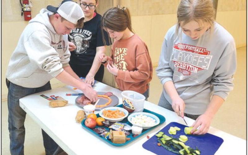 Members in Ochiltree County 4H’s Alamo Club tested their culinary skills last week on Monday as they worked to assemble snack boards, featuring meat, cheese, fruits, crackers, and candies. Pictured are, from left, Kyle Oquin, Emmalyn Overton, Hallie Lopez, and Emmalee Lopez.