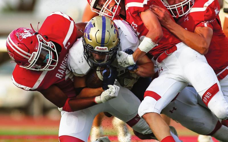 SEASON OPENER CUT SHORT The 2020 season opener at Ranger Field was cut short due to a power outage just minutes before the opening of the second half. A rabble of Rangers including senior Jacob Schollenbarger, #11; junior Cuyler Feger #5, and senior Pablo Perez #13 bring down the Dalhart running back late in the first quarter. (Photo by David Erickson)