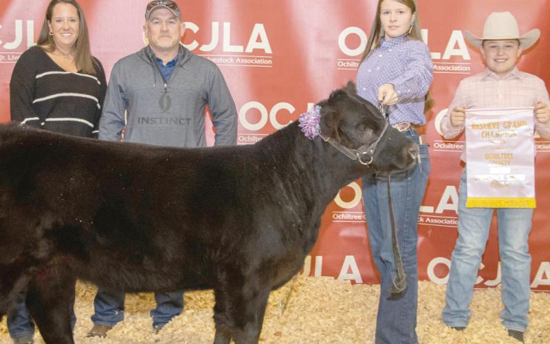 RESERVE GRAND CHAMPION HEIFER— At the Ochiltree County Junior Livestock Show and Sale, the prize for Reserve Grand Champion Heifer went to Tana Williams. Her animal was bought by Hansford County Vet, Hansford County Vet Supply, and TK Cattle. Pictured are, from left, Kris and Tod Keeth, Tana Williams, and Hadlee Cowan. (Photo credit: Tessa Powell)