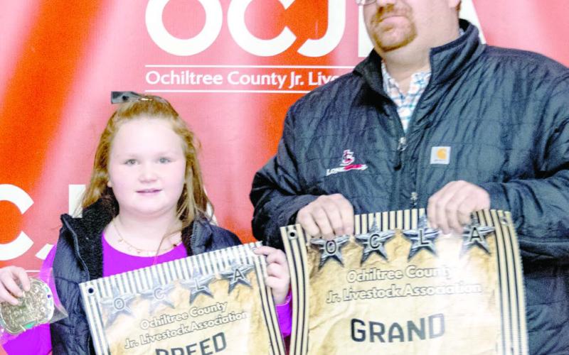 At the Ochiltree County Junior Livestock Show and Sale on Jan. 16-17, the prize for Grand Champion Sheep went to Bryar Herod. His animal was bought by Bank of Western Oklahoma-Woodward . Pictured are, from left, Bryar Herod and Matthew Gillispie. ( Photo credit: Hailey Clark of Hailey Renee Photography)