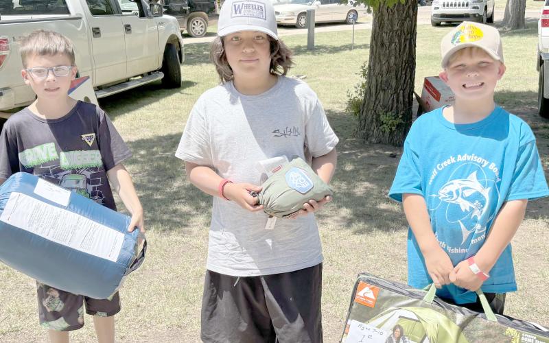 Enthusiastic young fishing fans came out for the Children’s Fishing Tournament at Lake Fryer and Wolf Creek Park at the beginning of June. Pictured are, from left, the top winners in the category for kids ages 7-10, Carson Barkley (third place), Christian Shipley (second place), and Slade Savard (first place).